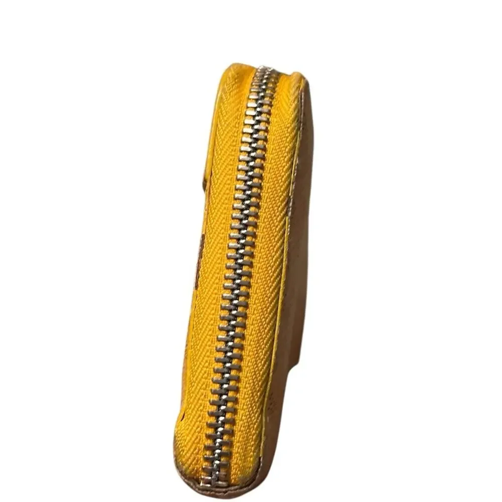 Goyard Matignon zip-around wallet in yellow orange Goyardine canvas.